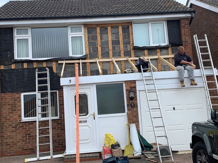 Roof and front works in progress on a detached house