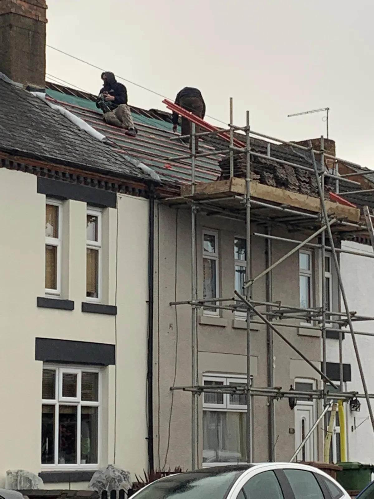 Scaffolding up for a roof replacement on a terraced house