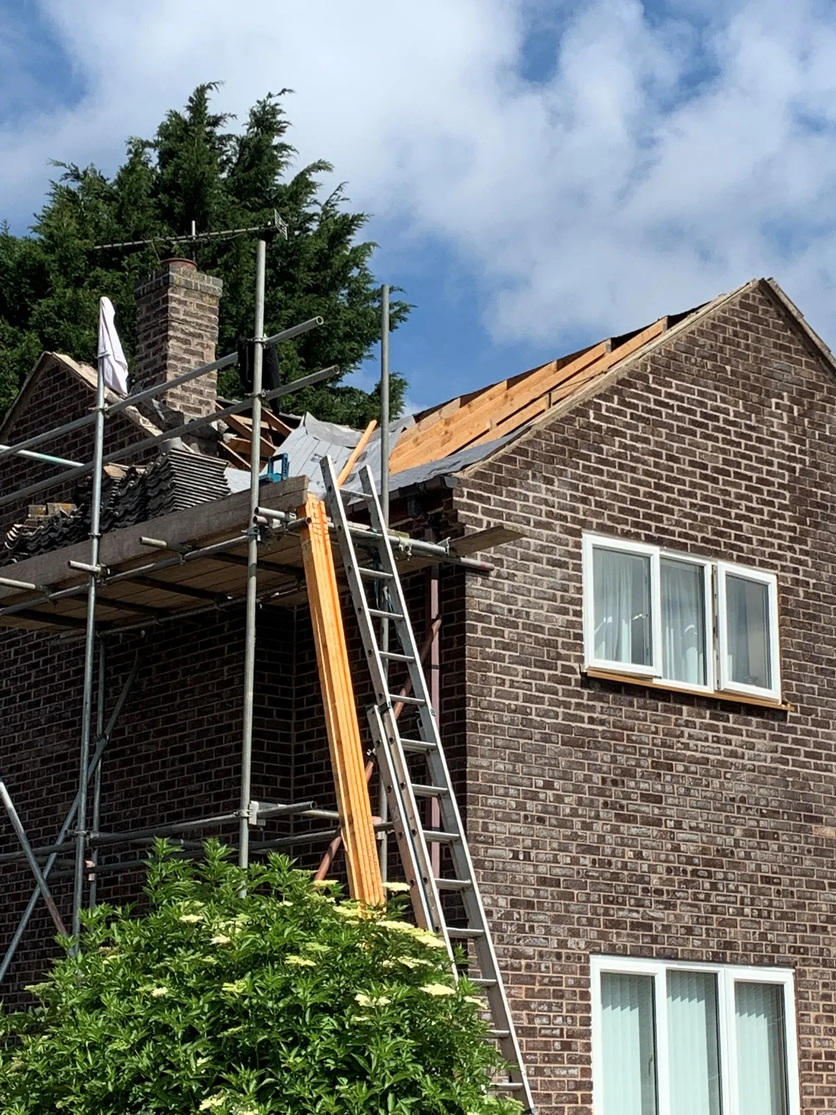 Roof replacement on a detached house with scaffolding