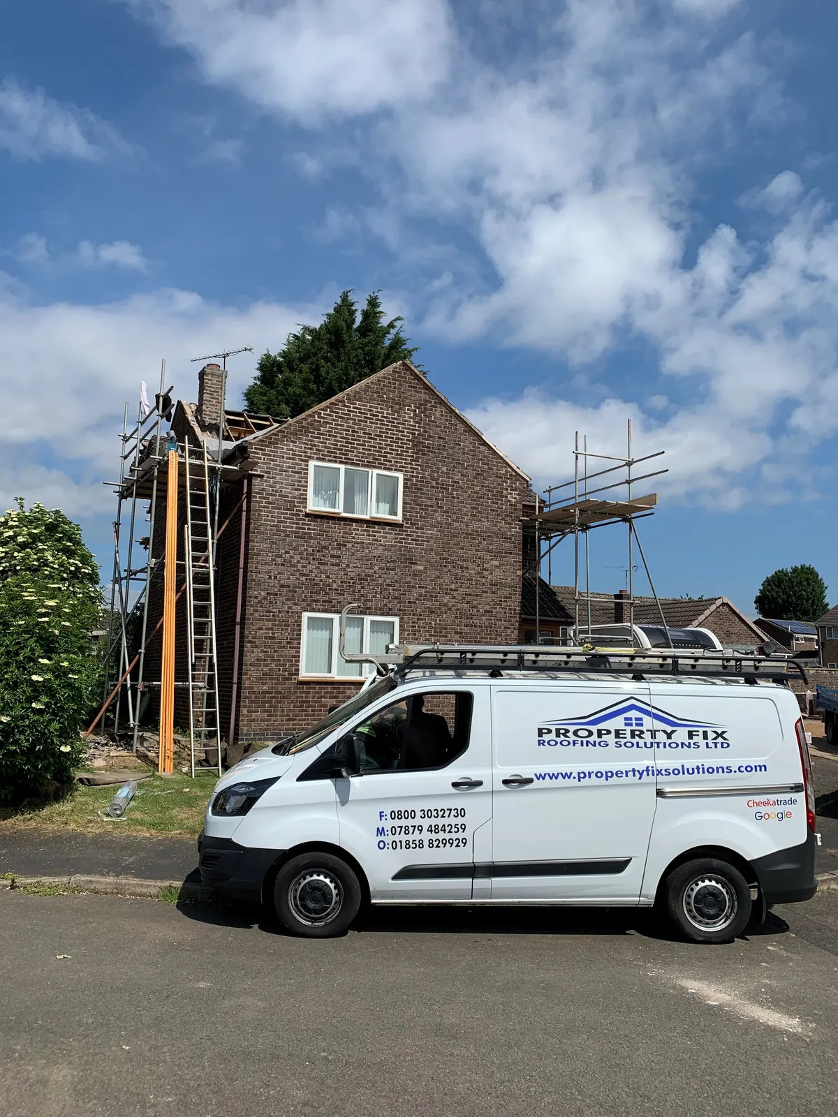 Scaffolding and the company van at a roof replacement