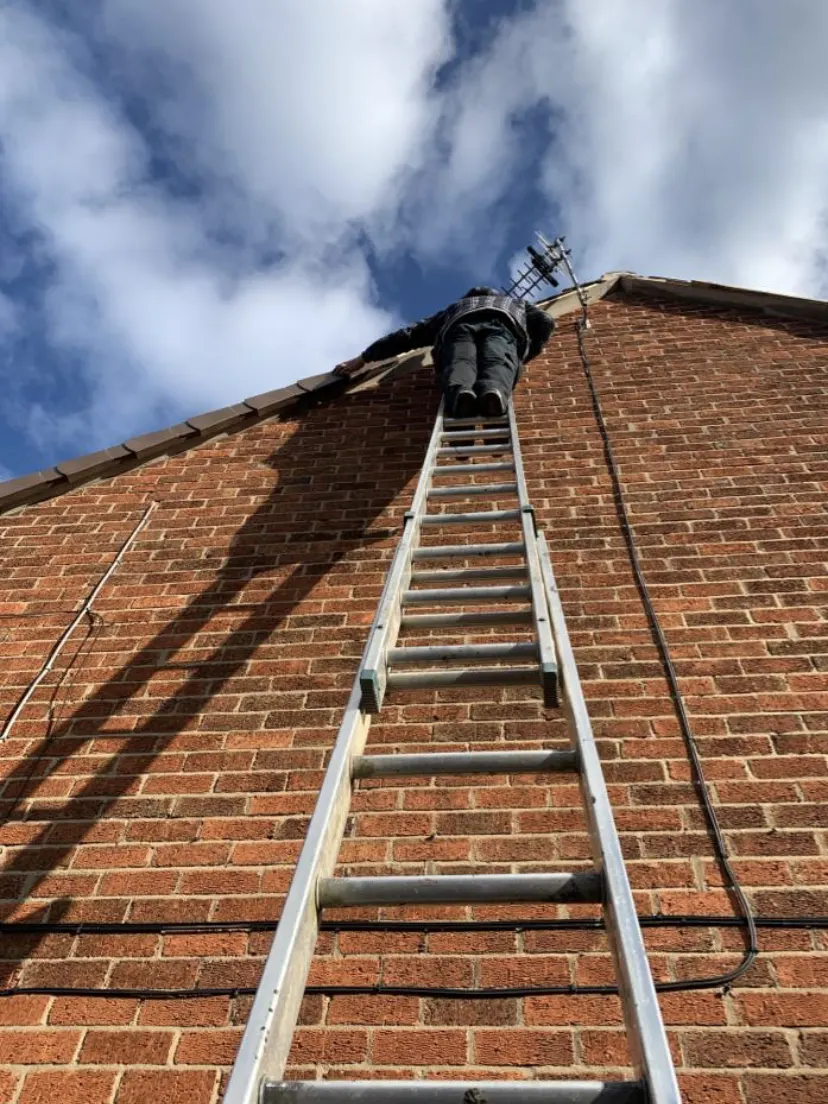 Ladder up to a chimney stack for repairs
